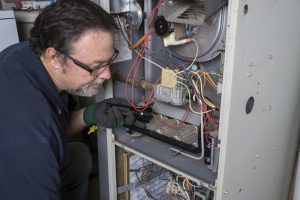 technician-examines-furnace